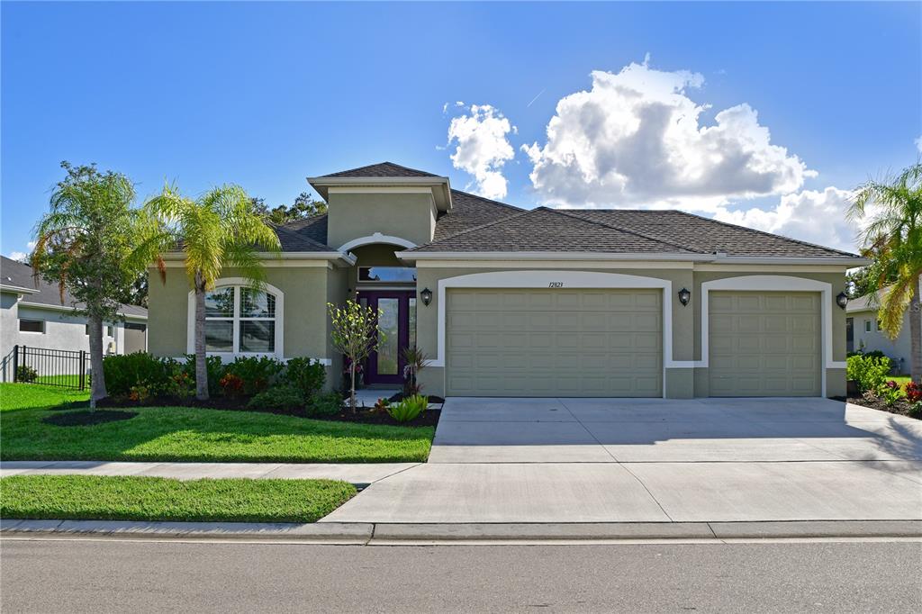 a front view of a house with a yard and garage