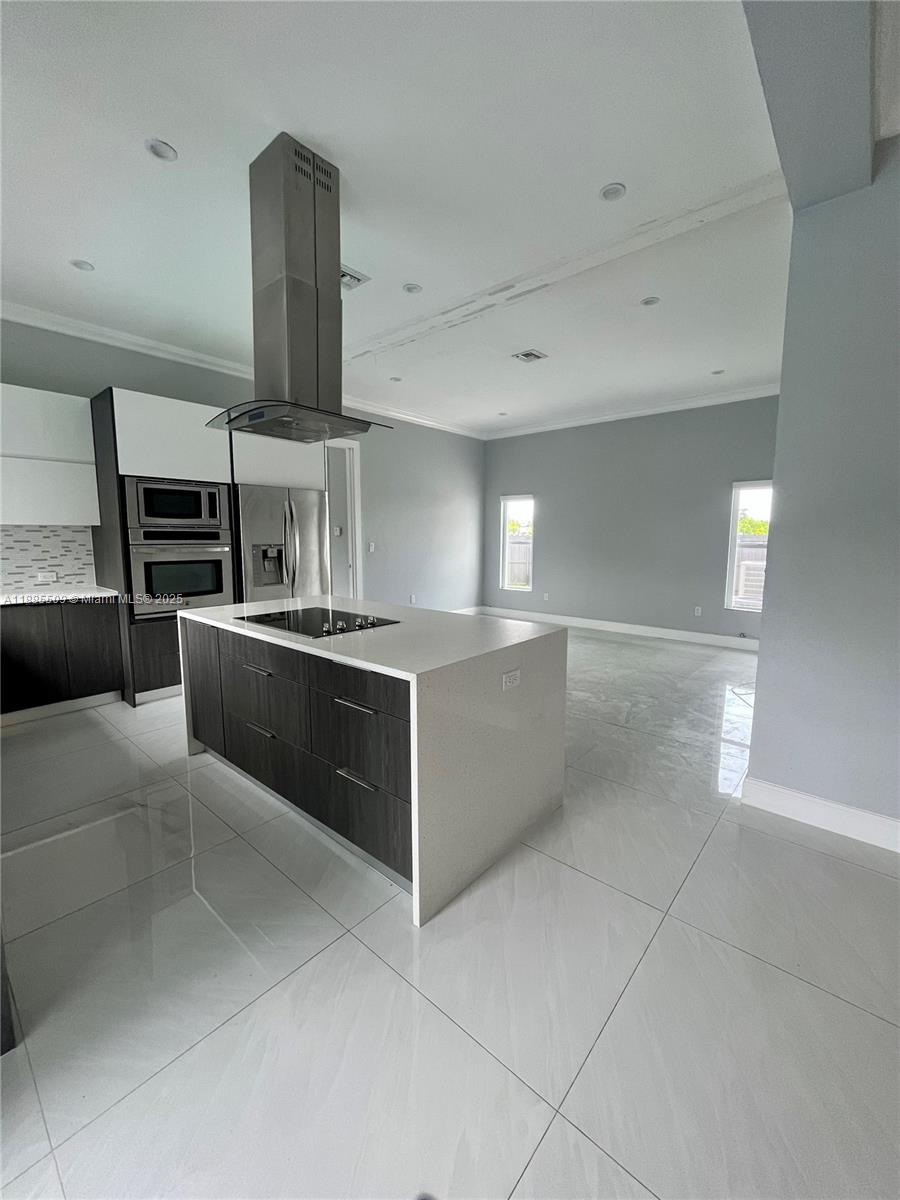 11921 Southwest 82nd Road Miami, FL 33156 - Photo 20 of 42 a large kitchen with cabinets and stainless steel appliances