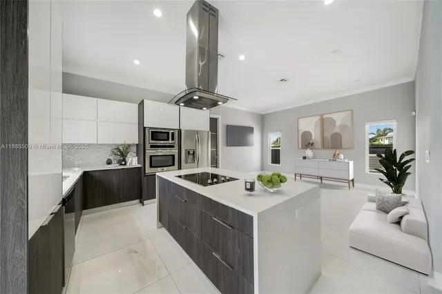 a kitchen with stainless steel appliances kitchen island a stove a table and chairs in it