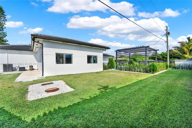 a backyard of a house with table and chairs