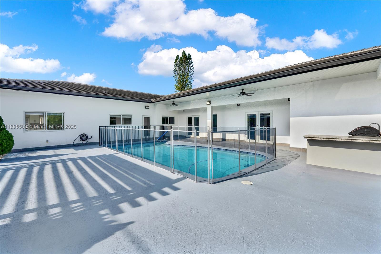 11921 Southwest 82nd Road Miami, FL 33156 - Photo 26 of 42 a swimming pool with outdoor seating and yard