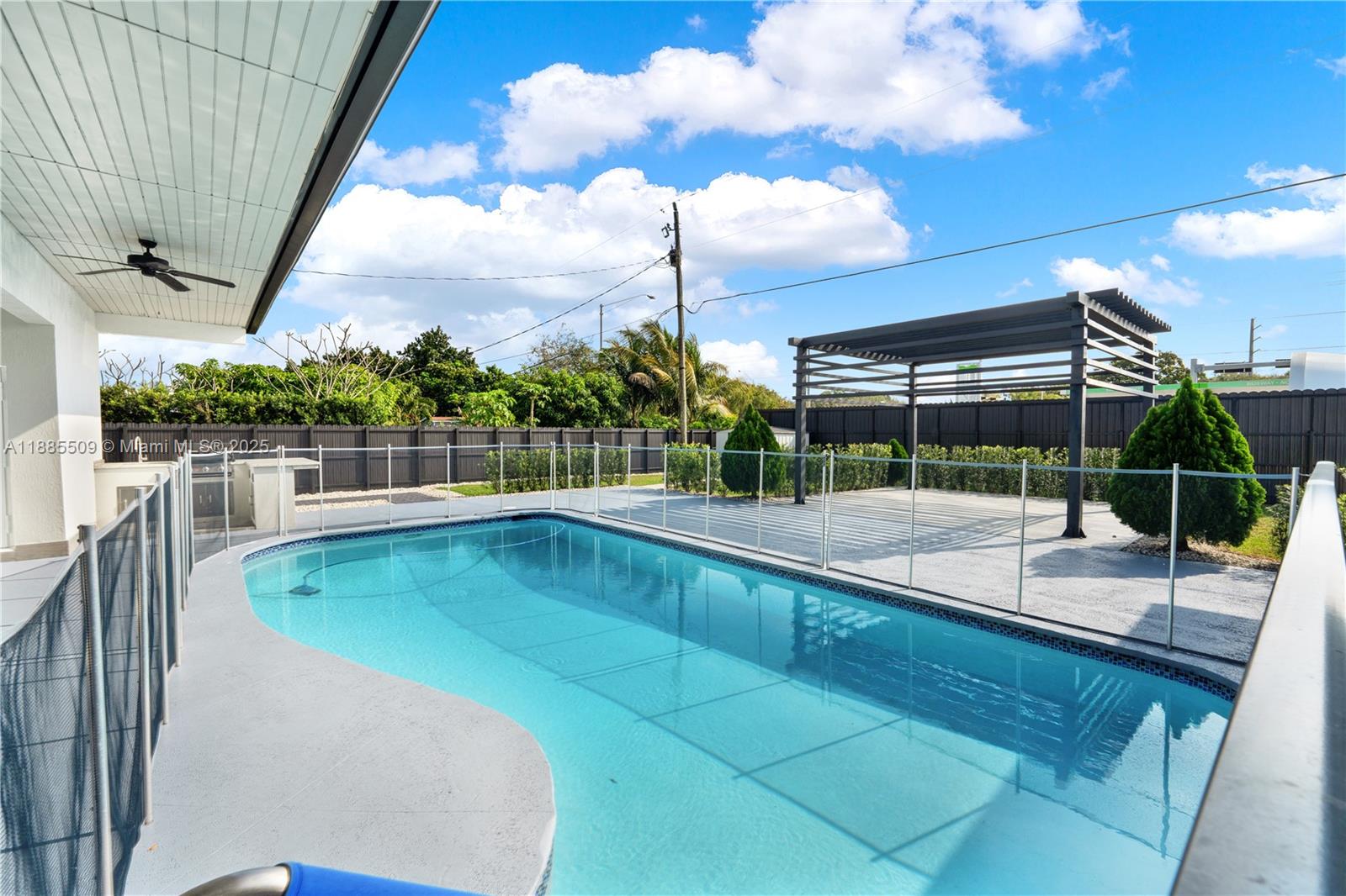 11921 Southwest 82nd Road Miami, FL 33156 - Photo 29 of 42 a view of a swimming pool with a patio