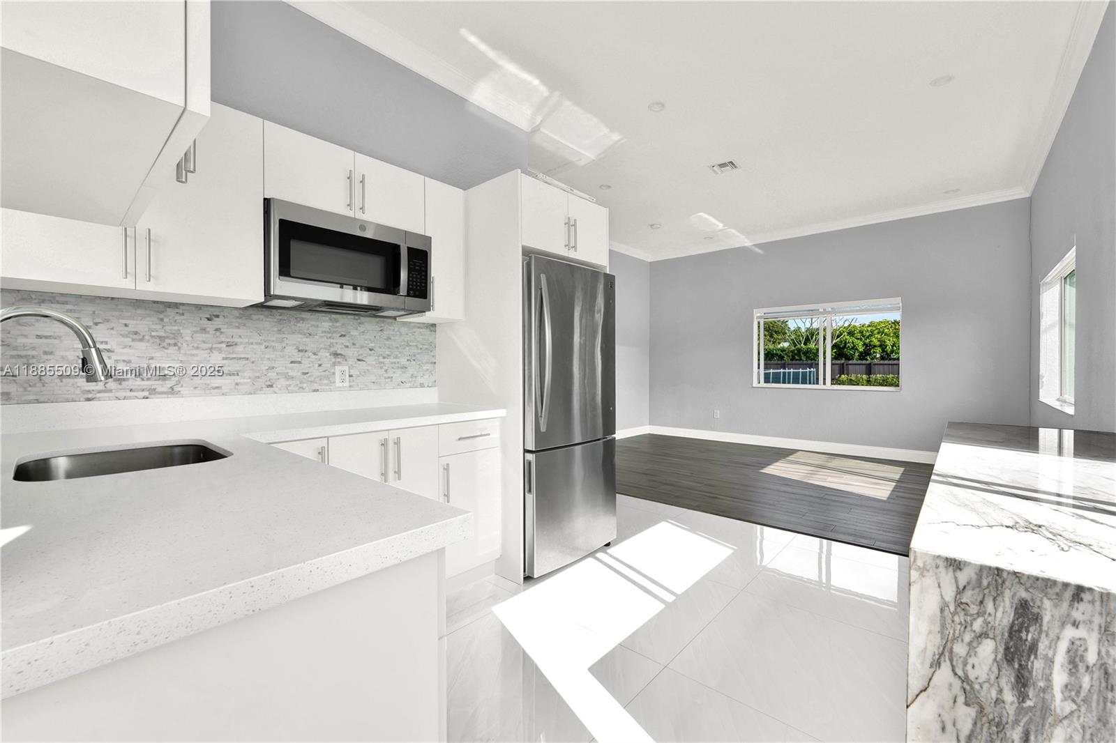 11921 Southwest 82nd Road Miami, FL 33156 - Photo 33 of 42 a kitchen with stainless steel appliances a stove microwave and sink