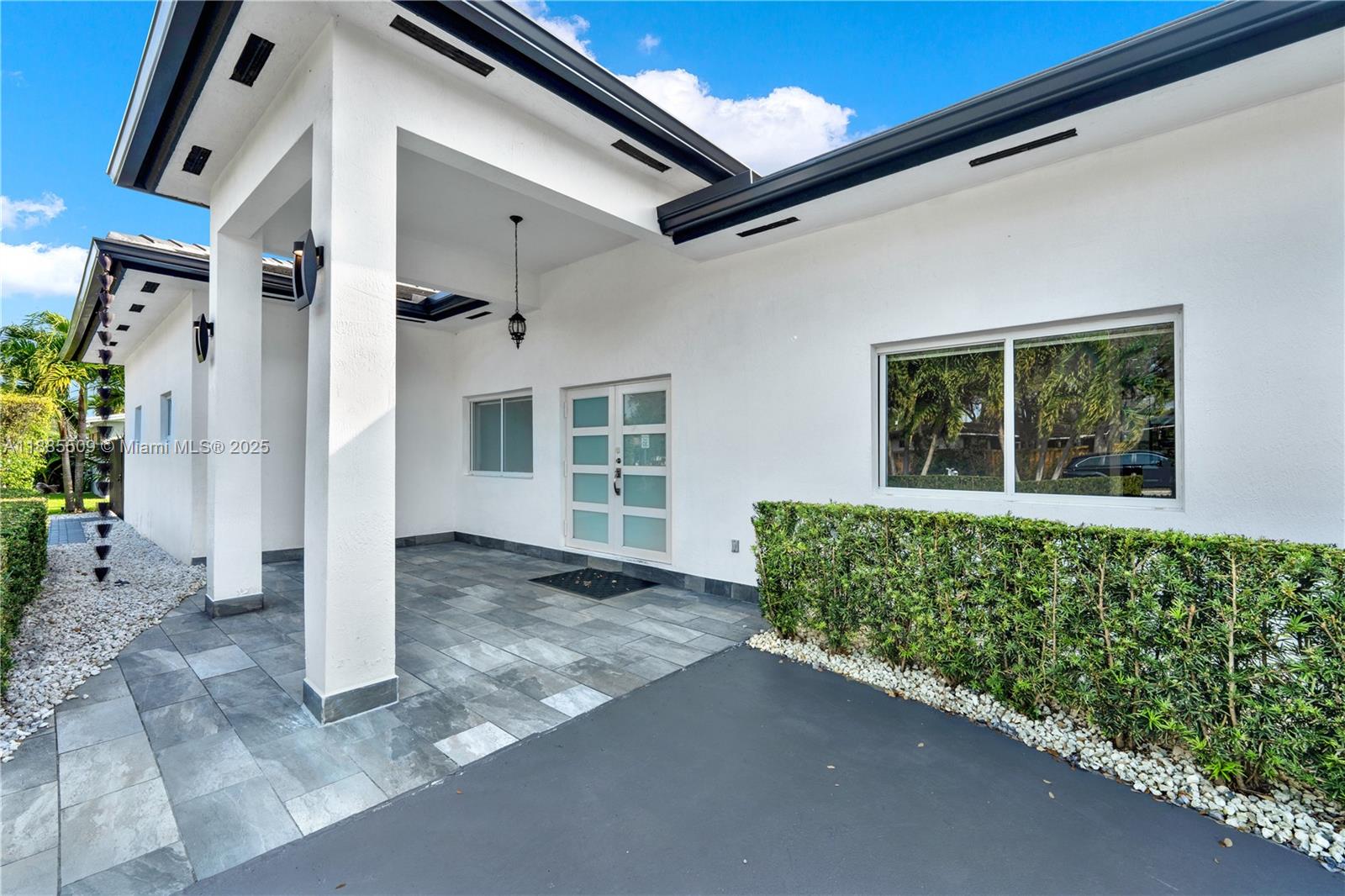 11921 Southwest 82nd Road Miami, FL 33156 - Photo 39 of 42 a view of a house with a plants and more windows
