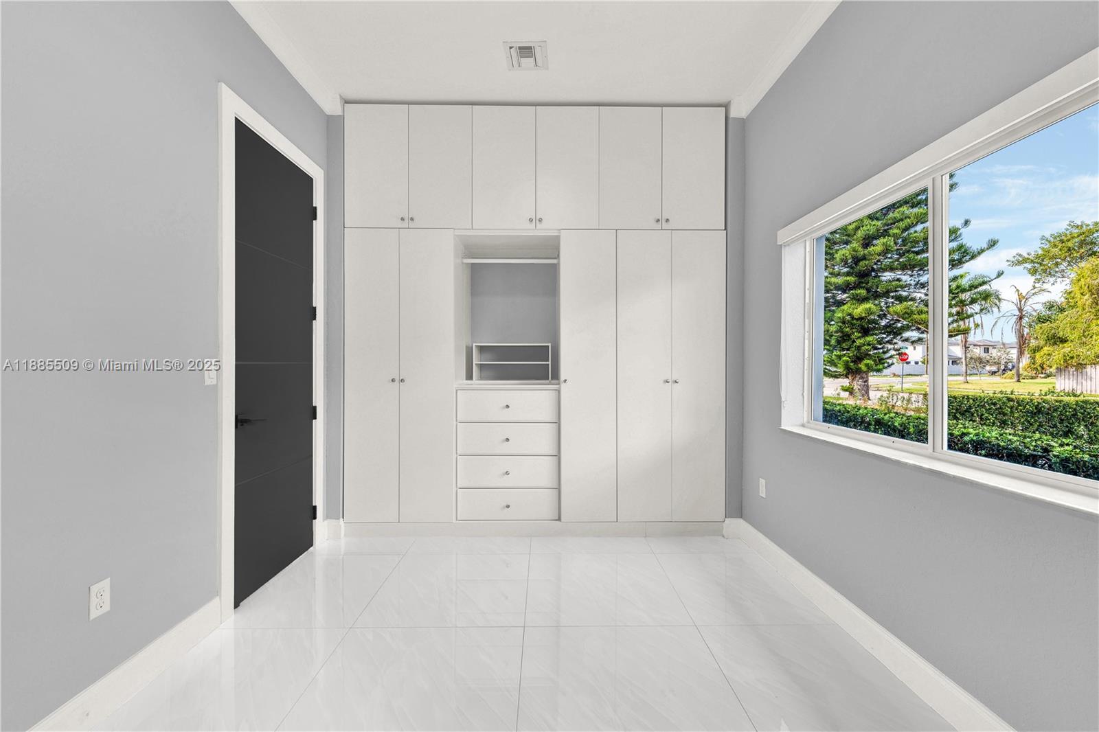 11921 Southwest 82nd Road Miami, FL 33156 - Photo 10 of 42 an empty room with windows and closet