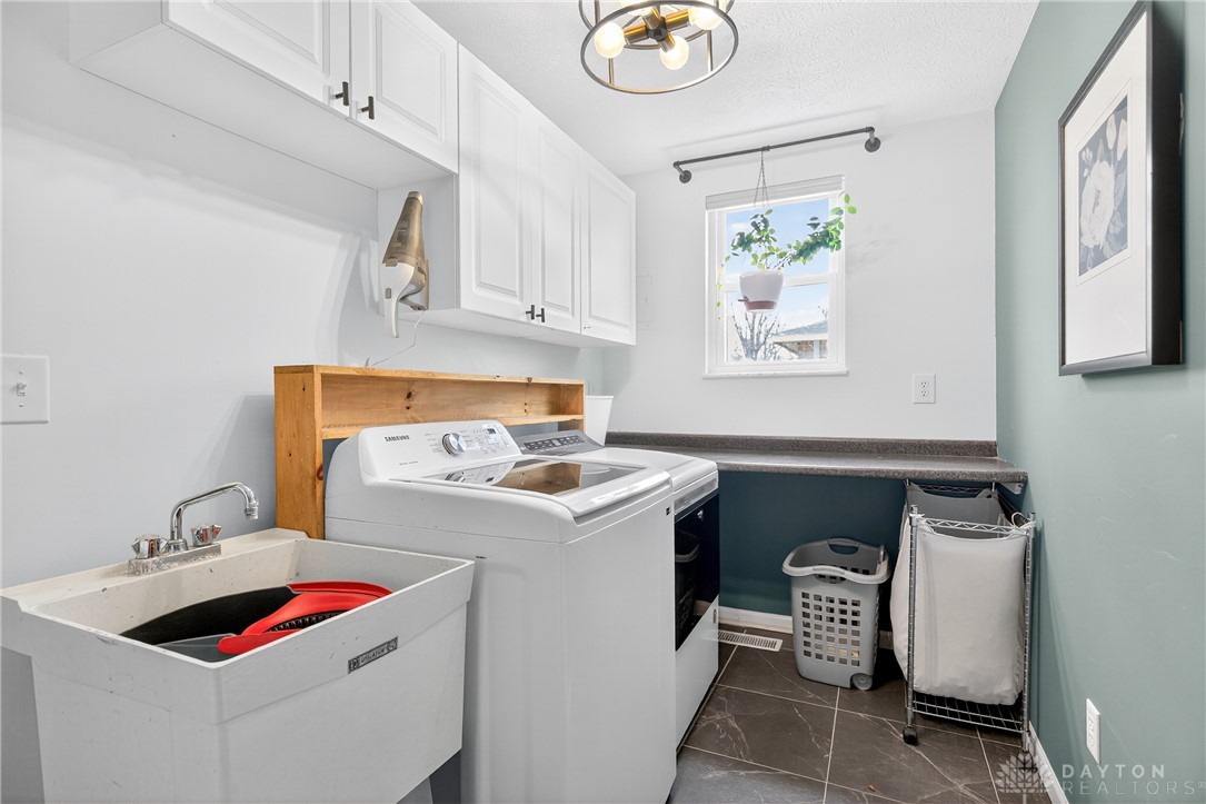 7888 Darke-Preble County Line Road Arcanum, OH 45304 - Photo 35 of 51 This functional laundry room features convenient amenities for everyday tasks.