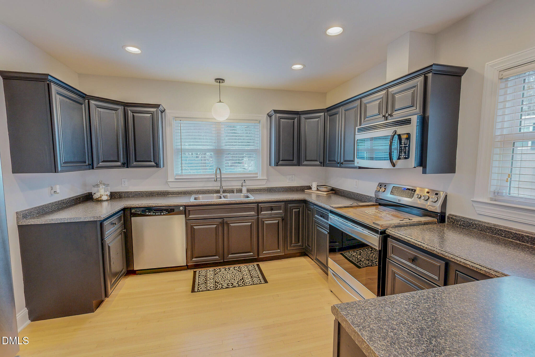421 Gordon Street Roxboro, NC 27573 - Photo 17 of 40 a kitchen with stainless steel appliances granite countertop a sink stove and cabinets