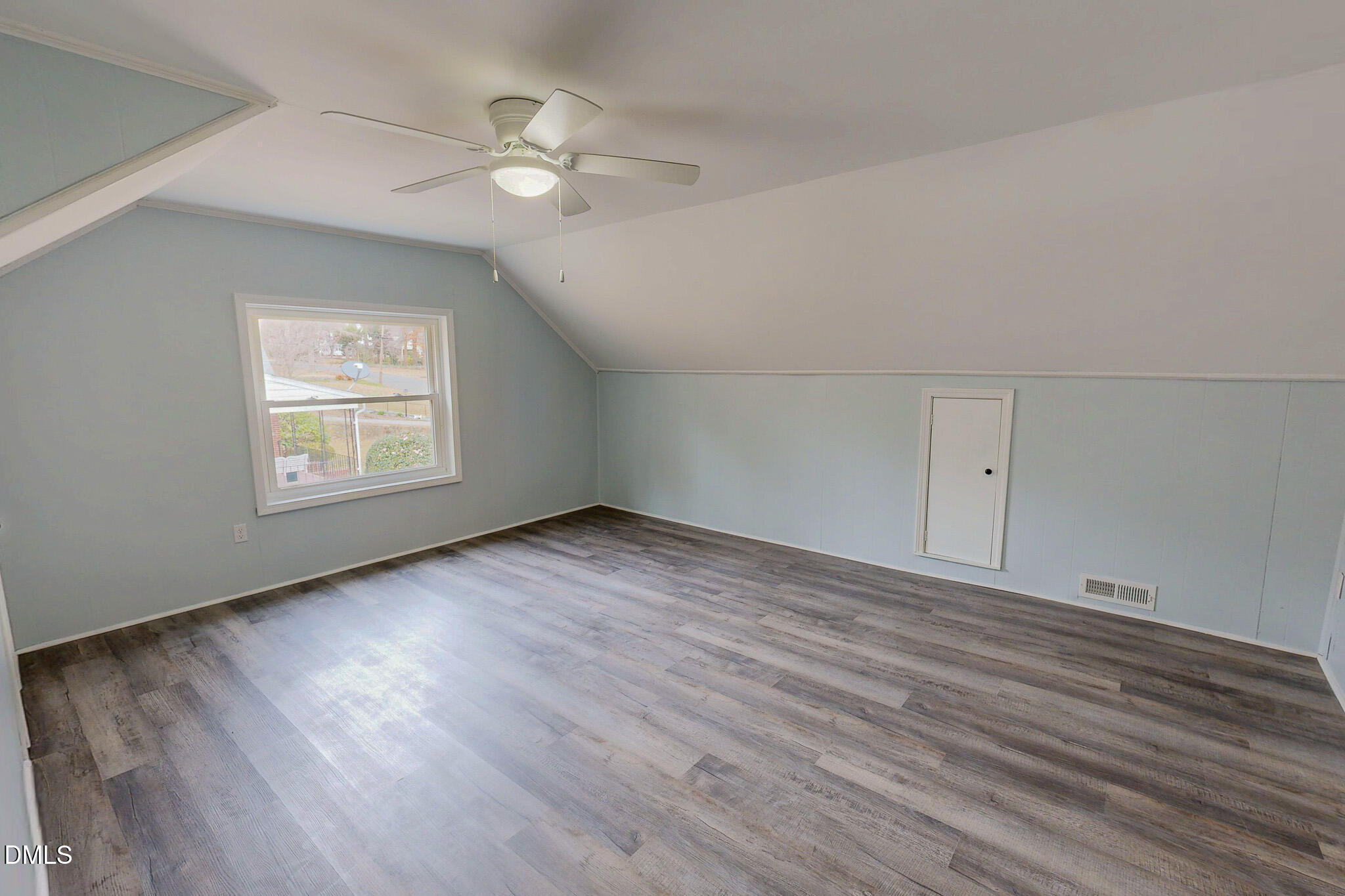 421 Gordon Street Roxboro, NC 27573 - Photo 36 of 40 an empty room with wooden floor chandelier fan and windows