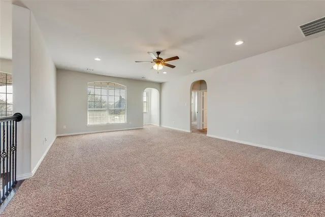 a view of a livingroom with a ceiling fan and window