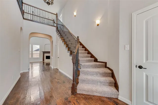 a view of entryway and hall with wooden floor