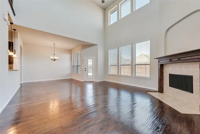 a view of a livingroom with wooden floor and a fireplace