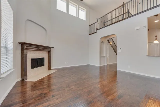a view of a livingroom with wooden floor and a fireplace