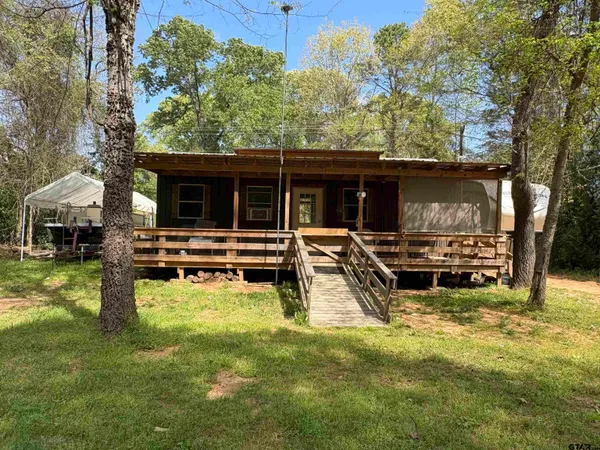 a view of a house with backyard porch and sitting area