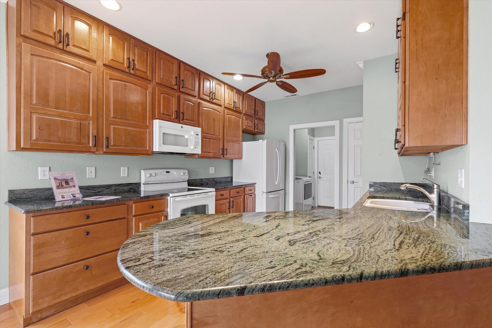 1908 S Prairie Urbana, IL 61802 - Photo 11 of 32 a kitchen with kitchen island granite countertop a sink cabinets and window
