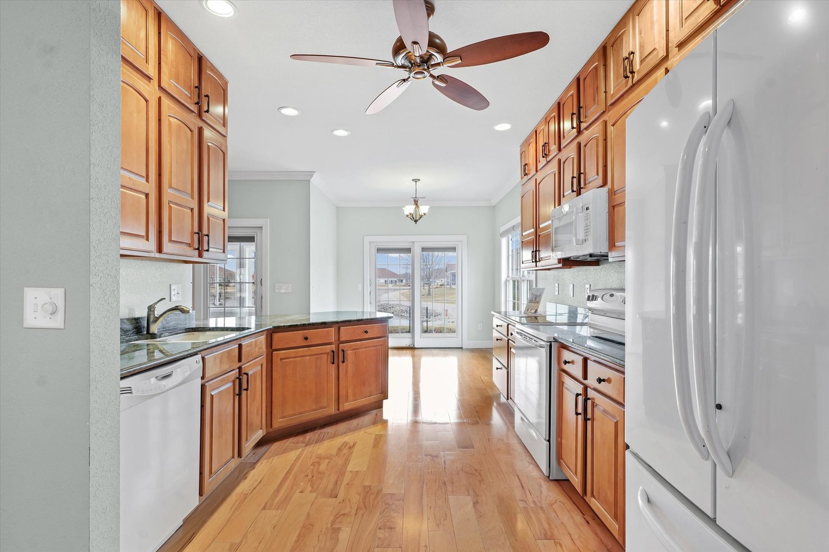 1908 S Prairie Urbana, IL 61802 - Photo 15 of 32 a large kitchen with stainless steel appliances granite countertop a lot of counter space and wooden floors