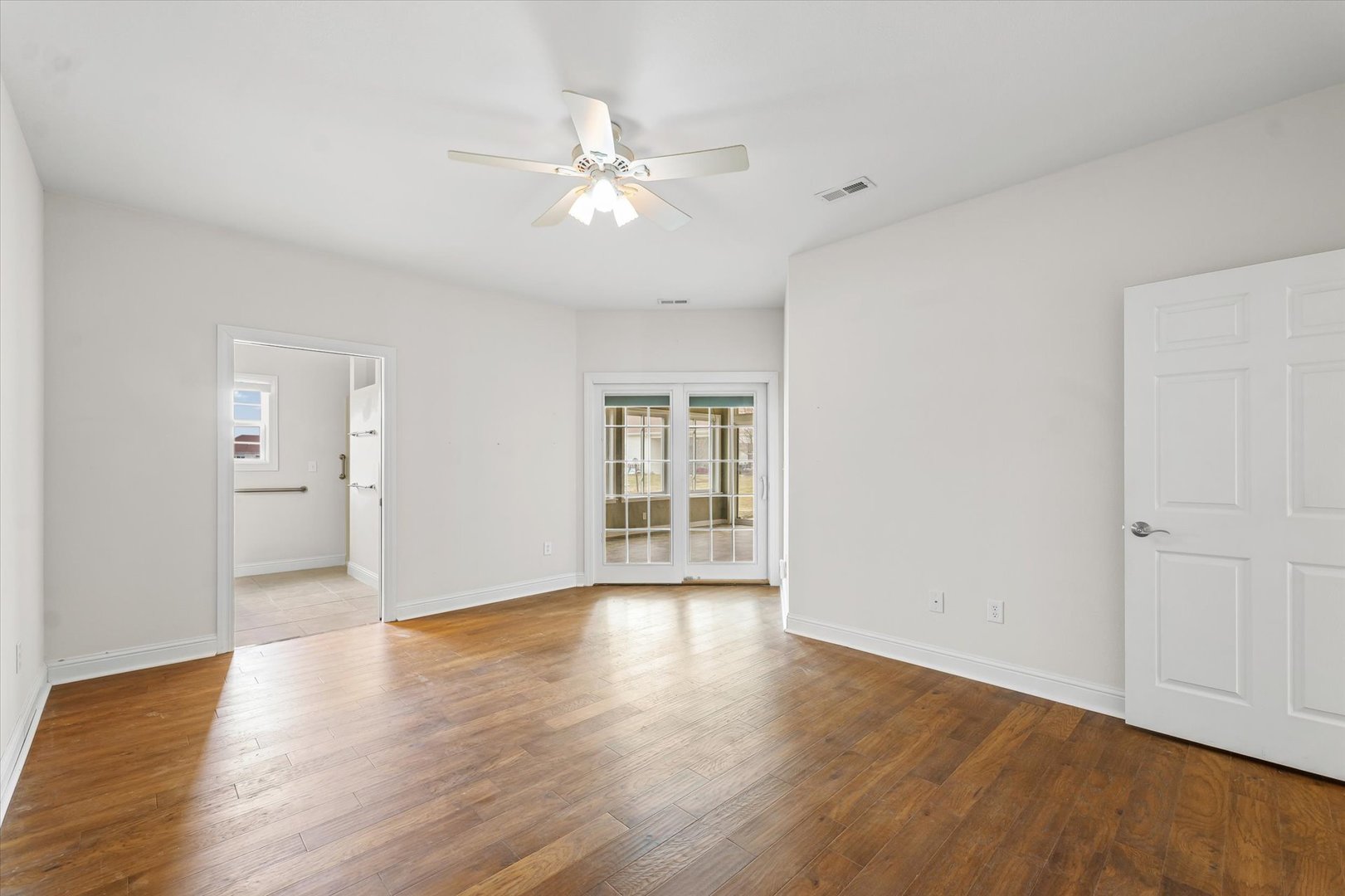 1908 S Prairie Urbana, IL 61802 - Photo 19 of 32 a view of an empty room with wooden floor and a window