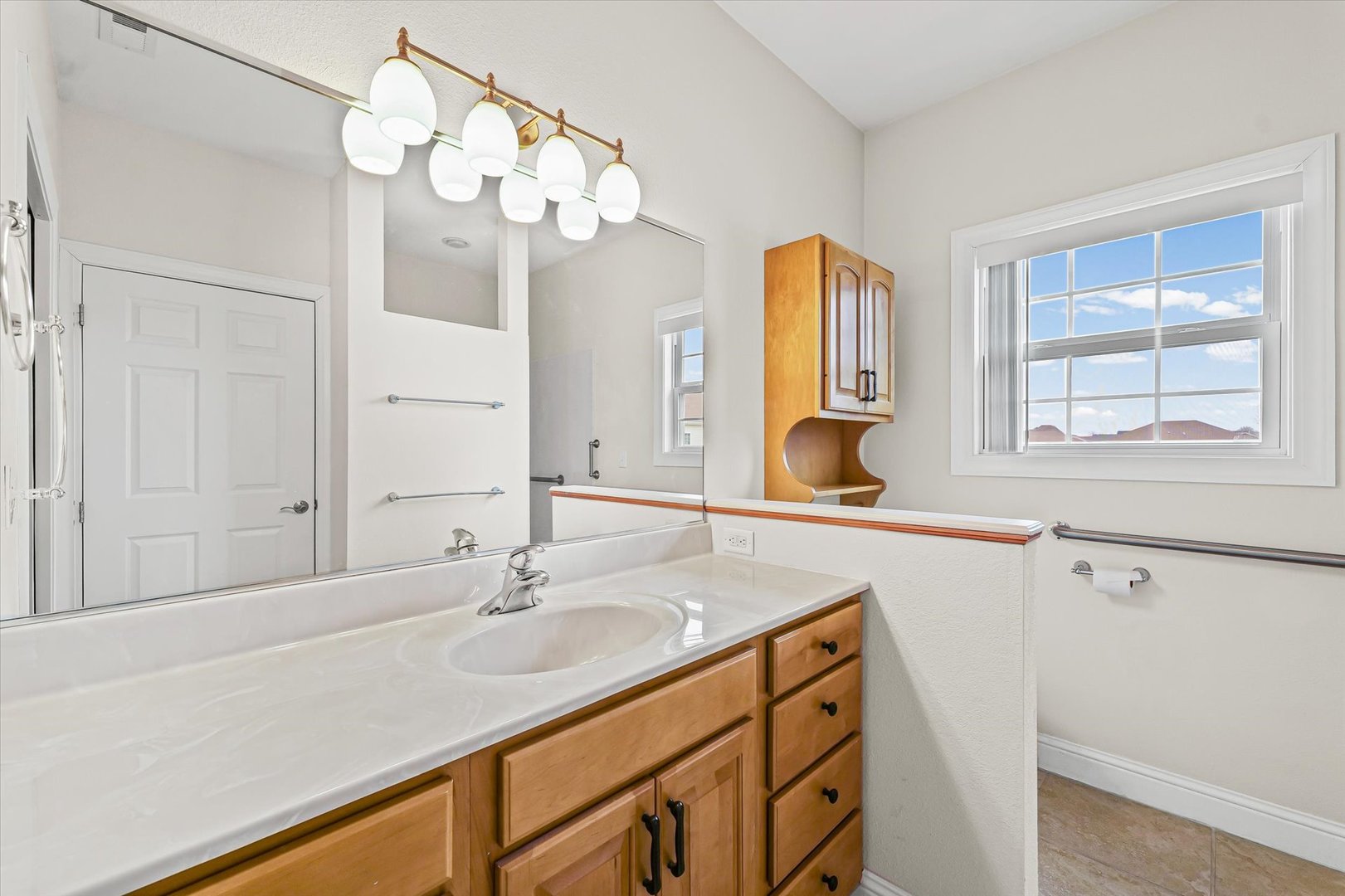 1908 S Prairie Urbana, IL 61802 - Photo 21 of 32 a bathroom with a sink a vanity and a mirror