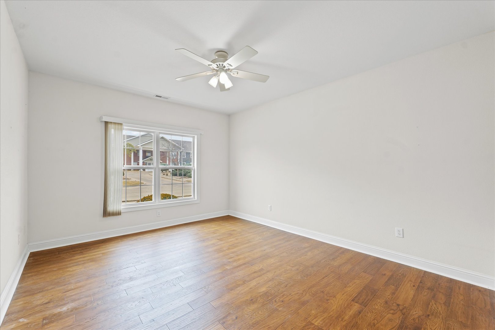 1908 S Prairie Urbana, IL 61802 - Photo 22 of 32 a view of an empty room with wooden floor and a window