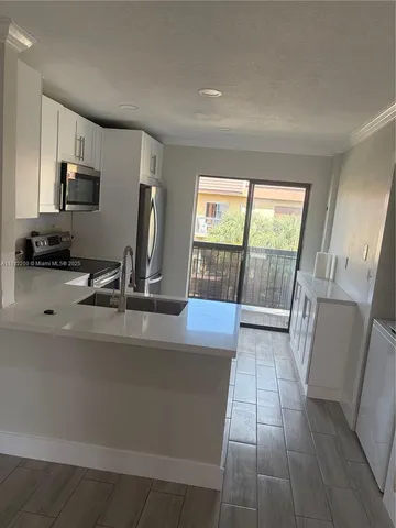 a view of a kitchen with a sink