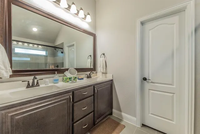 a bathroom with a double vanity sink and mirror