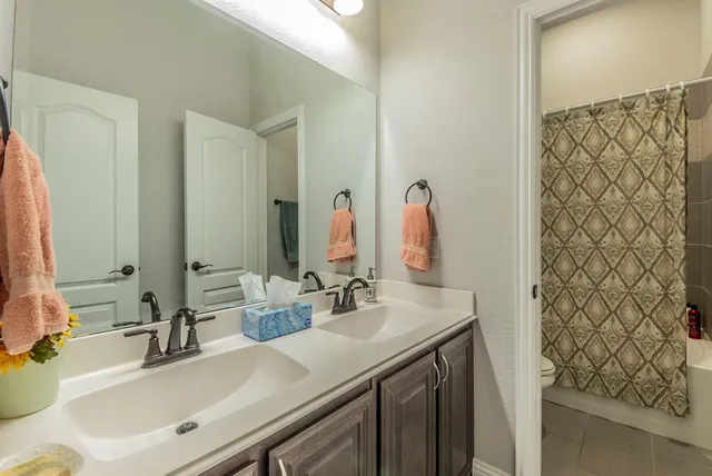 a bathroom with a sink vanity and a mirror