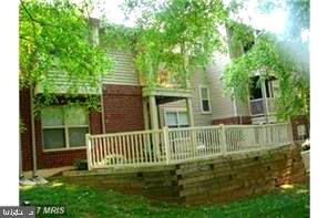 1711 Ascot Way, Unit B Reston, VA 20190 - Photo 1 of 13 a view of a house with a small yard and a large tree