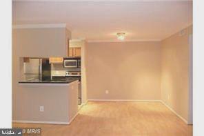 1711 Ascot Way, Unit B Reston, VA 20190 - Photo 3 of 13 a kitchen with granite countertop a refrigerator and a stove