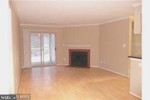 1711 Ascot Way, Unit B Reston, VA 20190 - Photo 4 of 13 a view of an empty room with a window