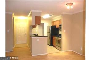1711 Ascot Way, Unit B Reston, VA 20190 - Photo 6 of 13 a kitchen with stainless steel appliances granite countertop a refrigerator and a stove