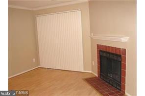 1711 Ascot Way, Unit B Reston, VA 20190 - Photo 7 of 13 a view of an empty room with a fireplace