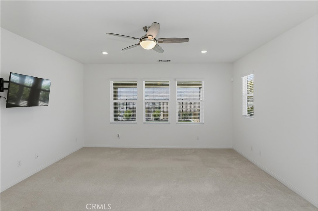 21159 Blue Jeans Court Riverside, CA 92507 - Photo 36 of 63 en empty room with windows and ceiling fan