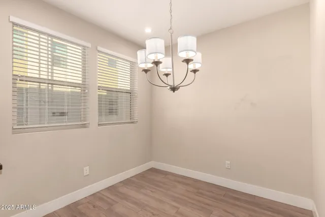 a view of a room with wooden floor and window