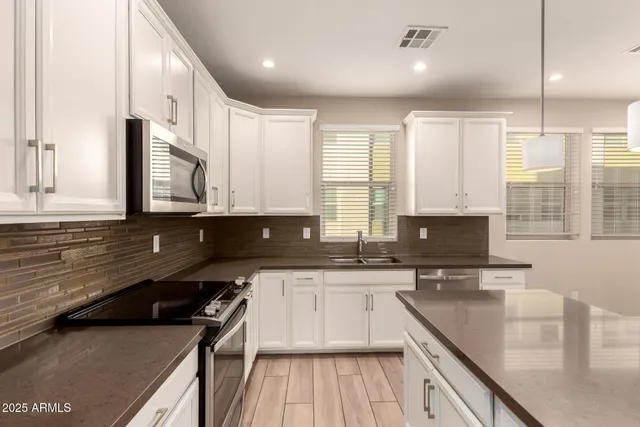 a kitchen with a sink stove and cabinets