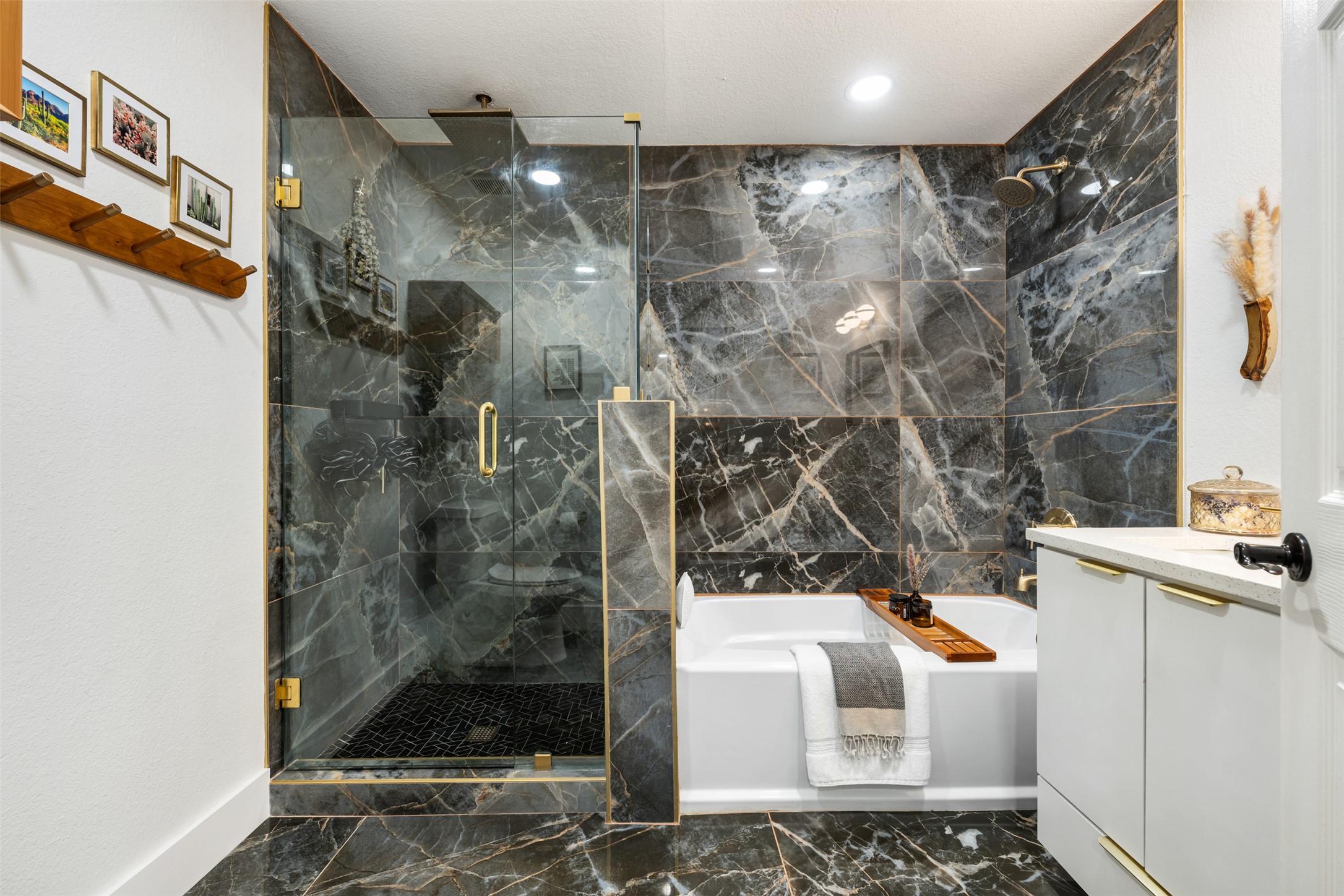 1616 Webberville Road, Unit A Austin, TX 78721 - Photo 5 of 35 Full bathroom featuring dark marble finish flooring, vanity, a garden tub, and a marble finish shower