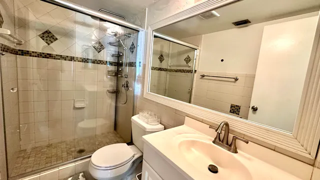 a bathroom with a sink toilet and shower