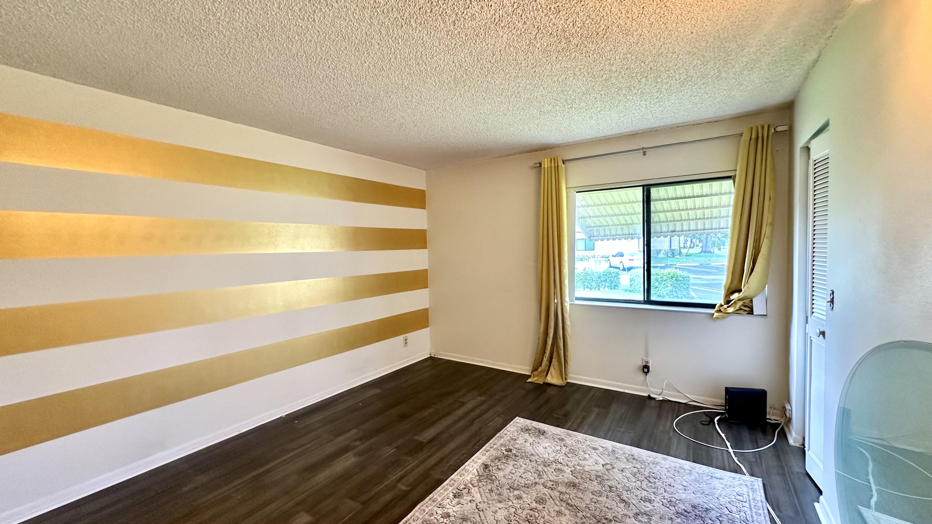 533 Shady Pine Way, Unit B1 Greenacres, FL 33415 - Photo 13 of 19 a view of a room with wooden floor and a window
