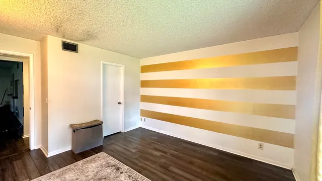 a view of an empty room and wooden floor