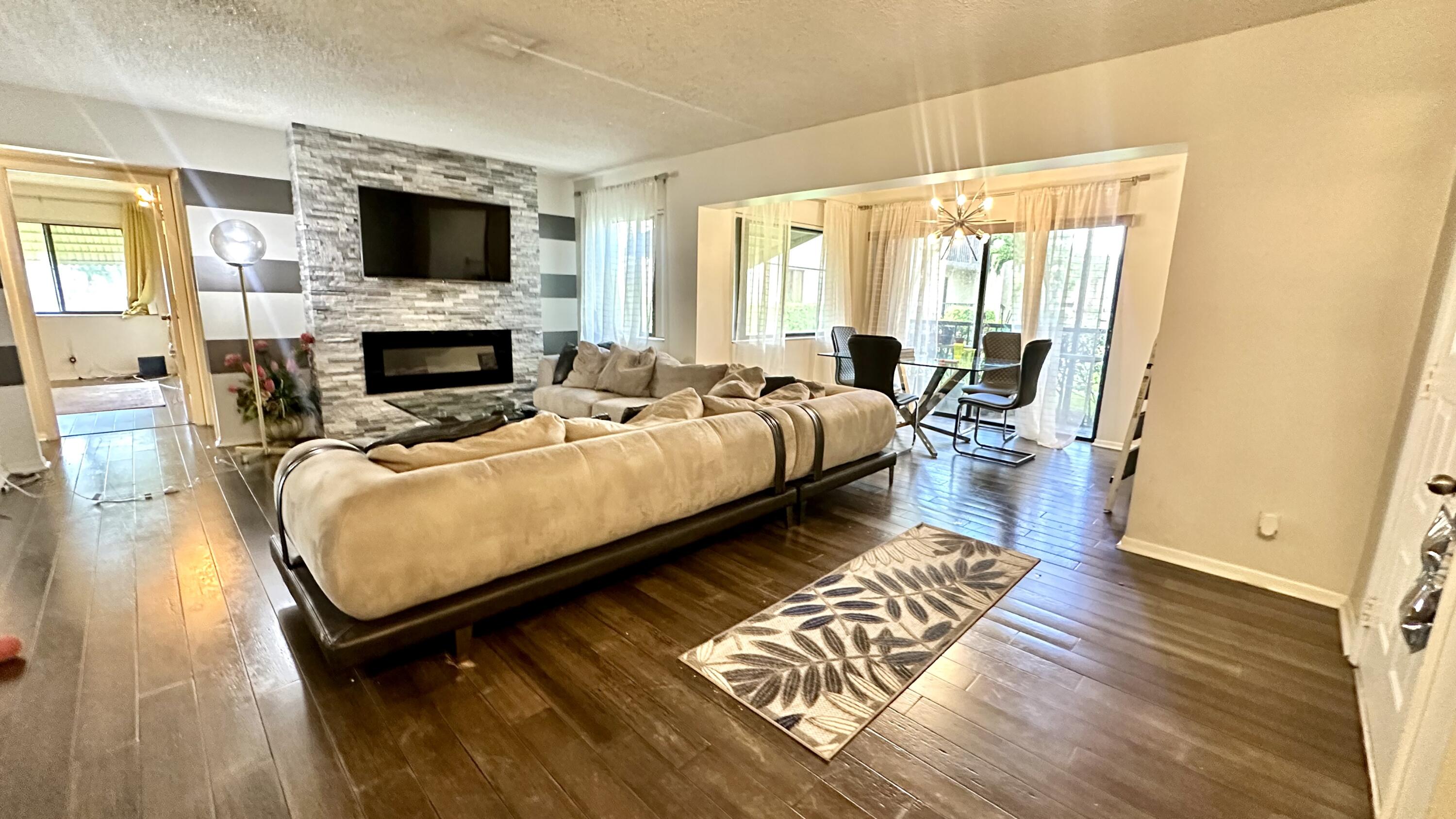 533 Shady Pine Way, Unit B1 Greenacres, FL 33415 - Photo 17 of 19 a living room with furniture and a fireplace