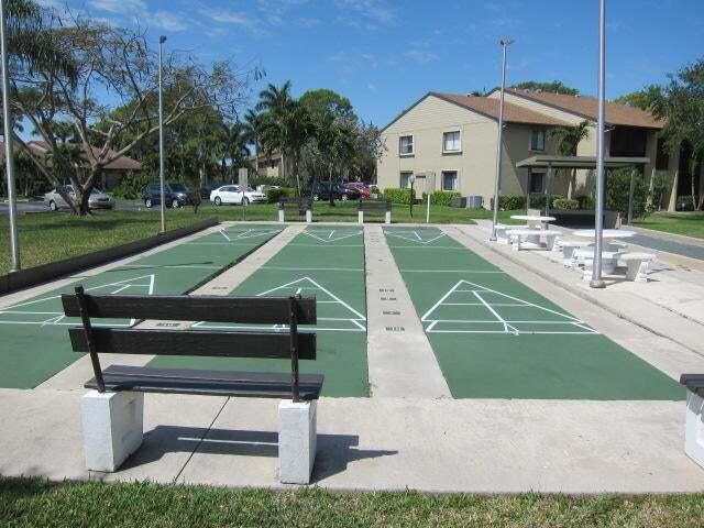 533 Shady Pine Way, Unit B1 Greenacres, FL 33415 - Photo 18 of 19 a view of a house with a yard