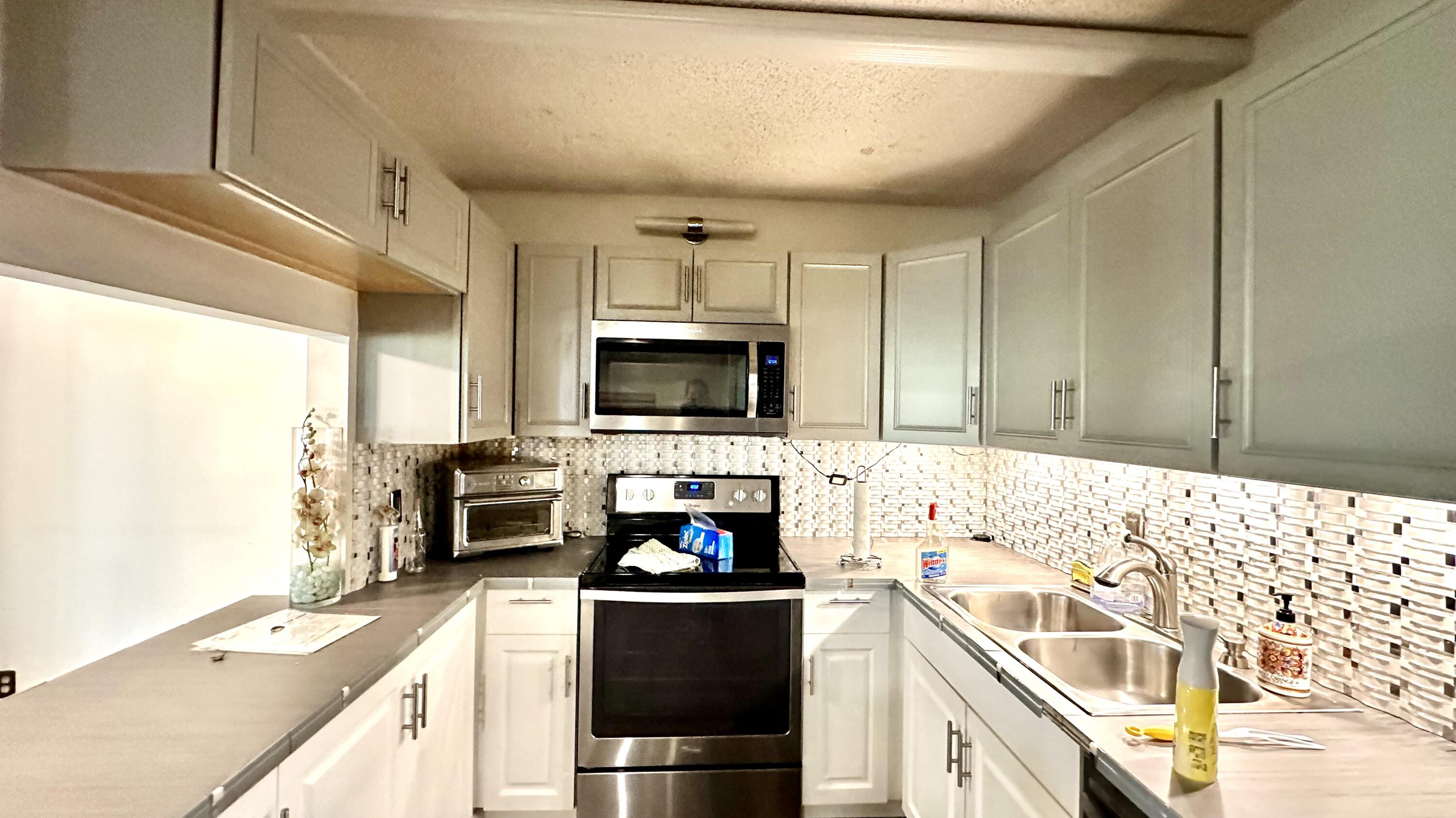 533 Shady Pine Way, Unit B1 Greenacres, FL 33415 - Photo 2 of 19 a kitchen with a sink a stove and cabinets