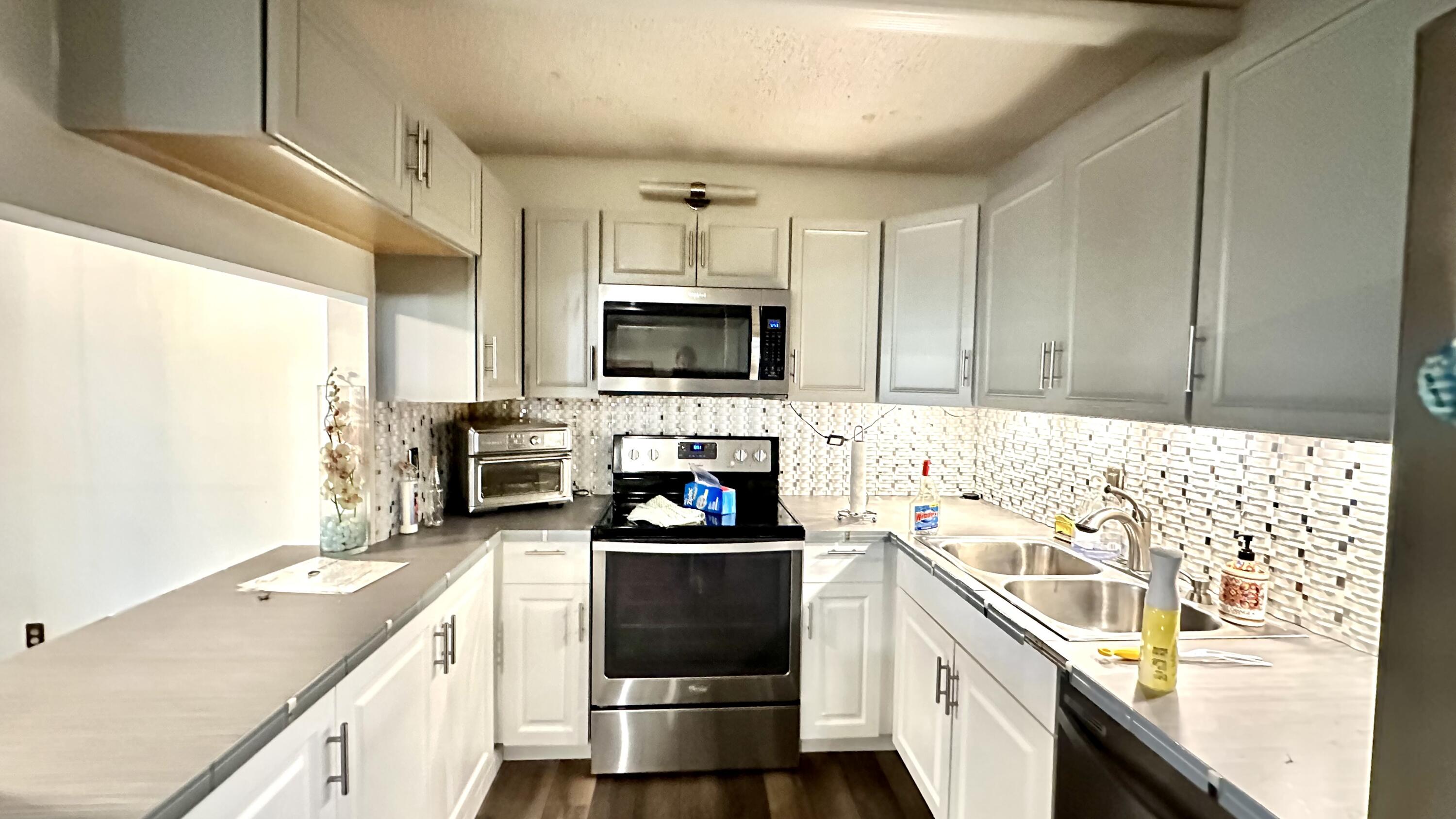 533 Shady Pine Way, Unit B1 Greenacres, FL 33415 - Photo 4 of 19 a kitchen with a sink stove top oven and refrigerator