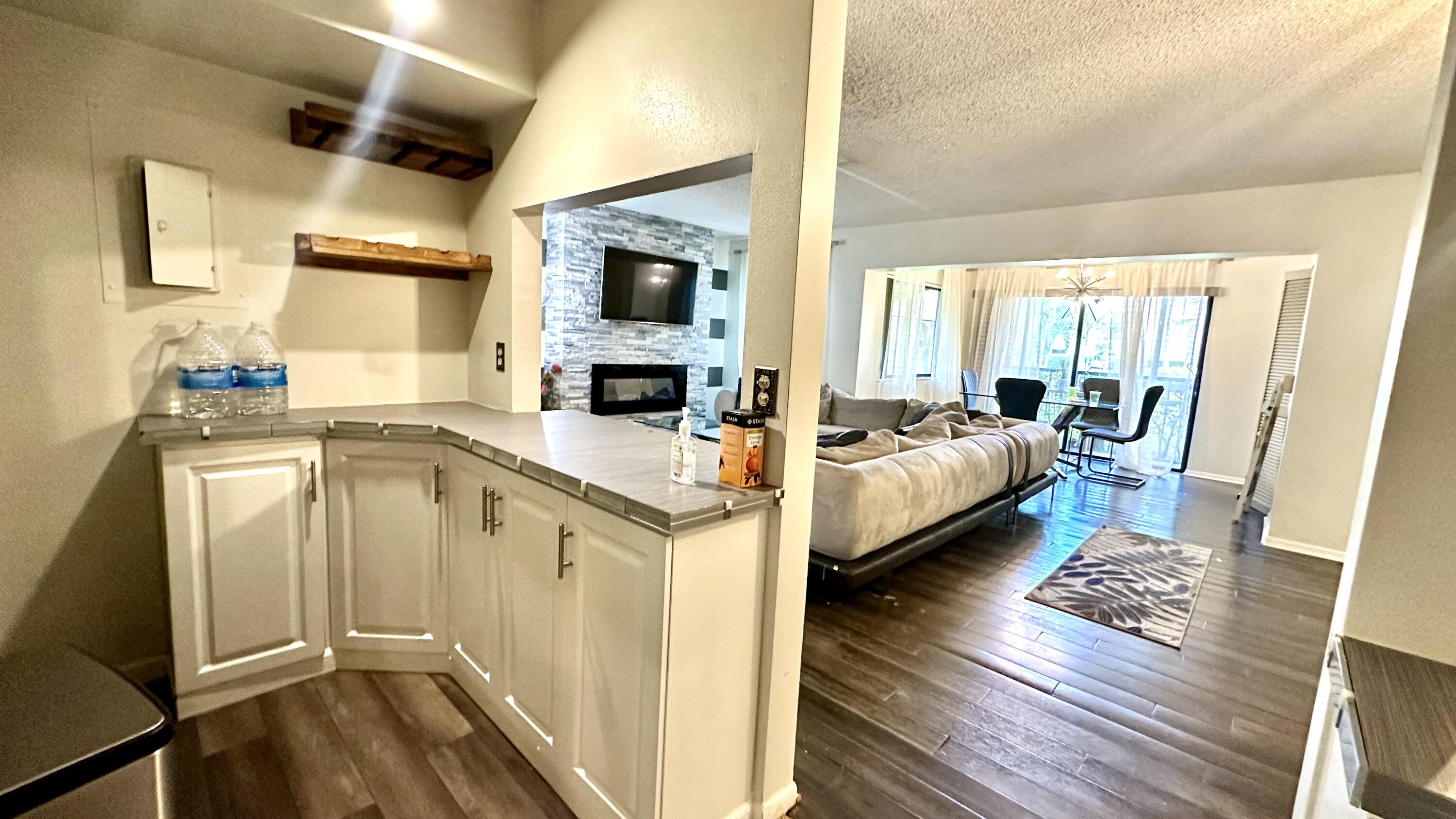 533 Shady Pine Way, Unit B1 Greenacres, FL 33415 - Photo 5 of 19 a spacious bedroom with a bed a table and wooden floor