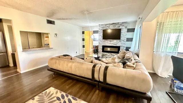 a living room with a bed furniture and a flat screen tv