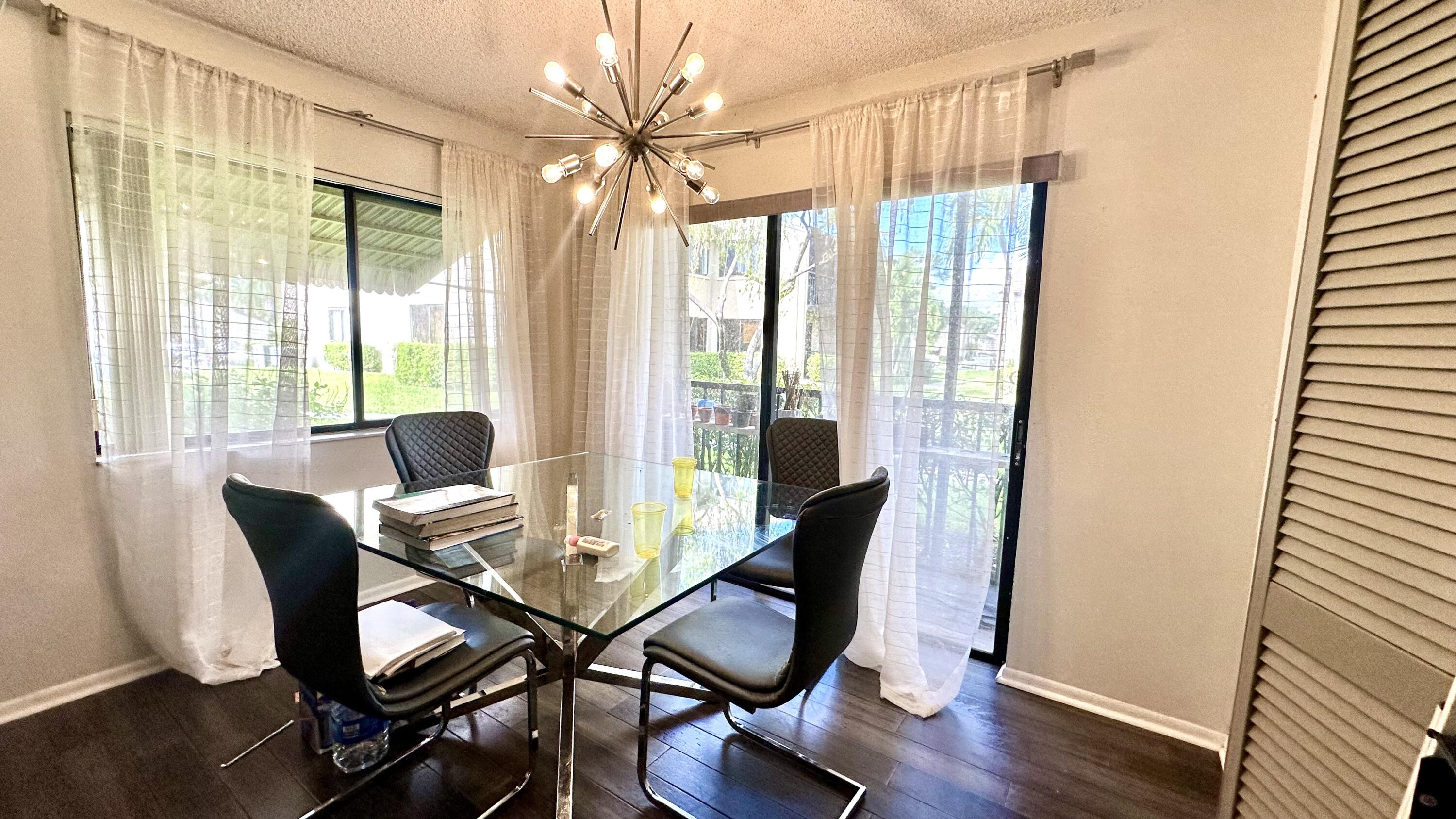 533 Shady Pine Way, Unit B1 Greenacres, FL 33415 - Photo 7 of 19 a view of a dining room with furniture window and wooden floor