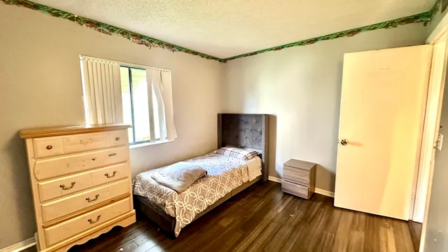 a bedroom with a bed and a dresser