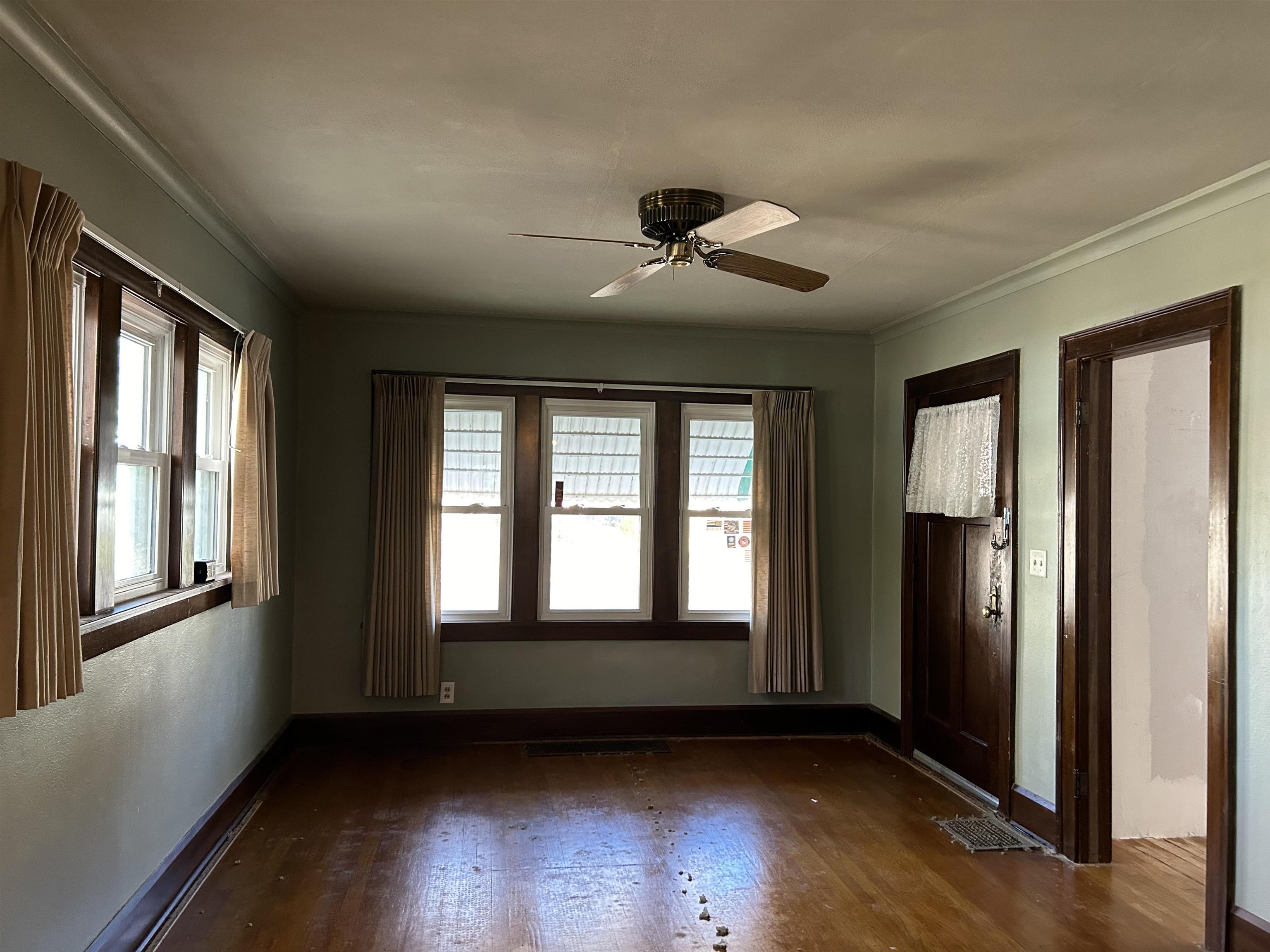 1922 Bruner Street Rockford, IL 61103 - Photo 6 of 18 a view of an empty room with wooden floor and a window