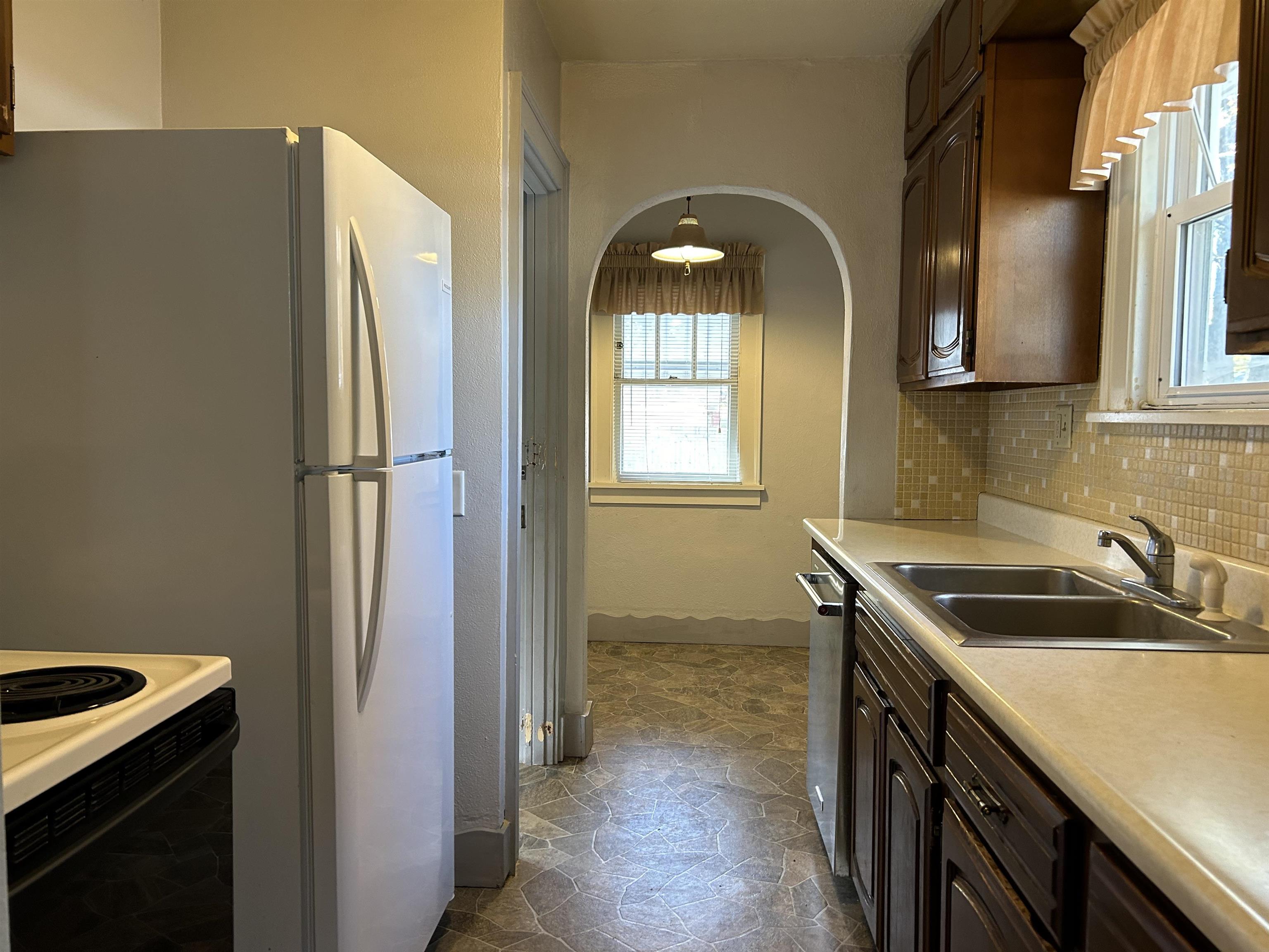 1922 Bruner Street Rockford, IL 61103 - Photo 8 of 18 a kitchen with a sink a refrigerator and cabinets