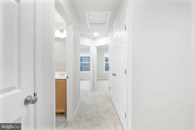 a view of a hallway with wooden shelves