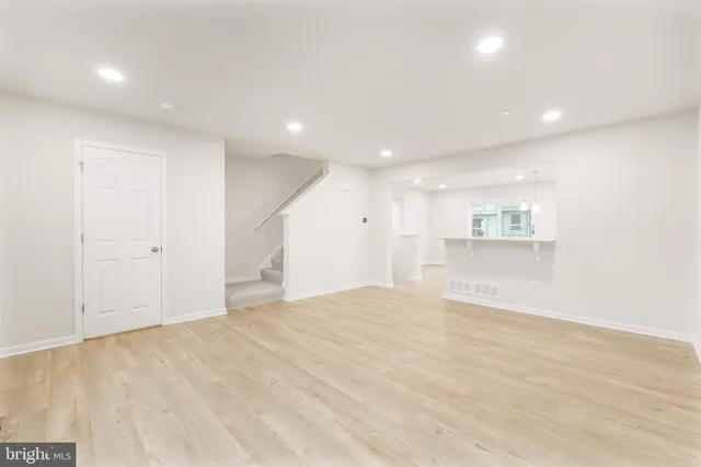 a view of an empty room with a kitchen