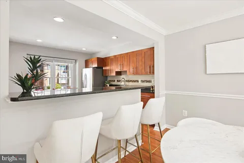 a kitchen with a stove a refrigerator and a sink